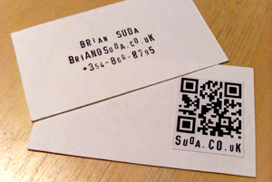 A QR code for a vCard on the back of business cards